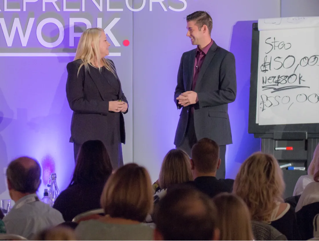 Pam and Zander on stage in front of business owners